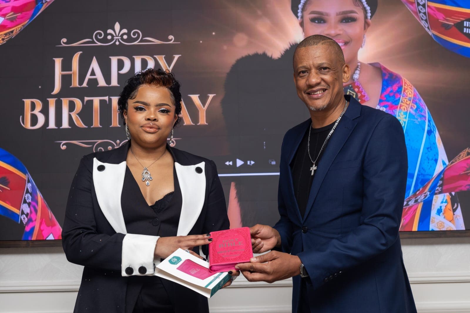 Dr. Keith Clint Harrington presenting a Bible to the Principal Princess on her birthday