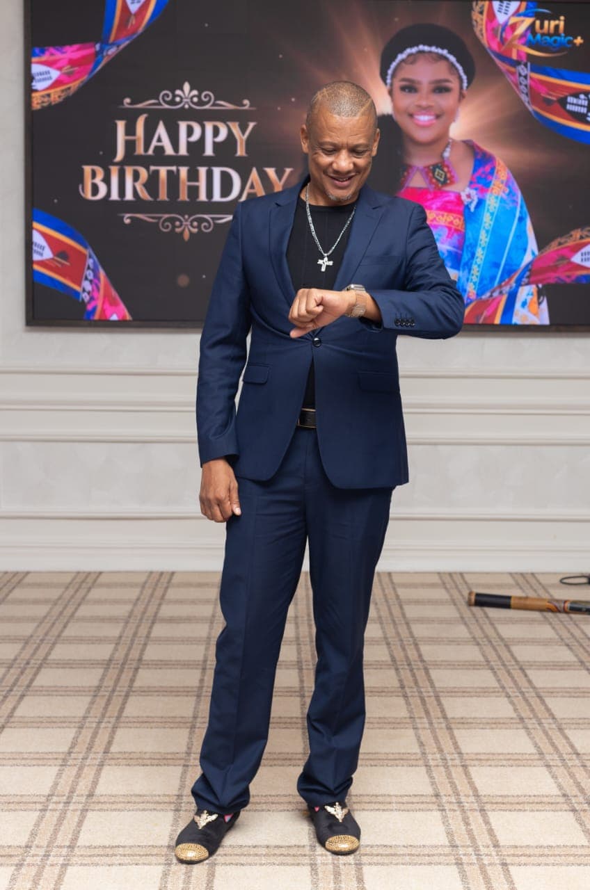 A candid moment with Dr. Keith Clint Harrington at the Principal Princess's birthday celebration