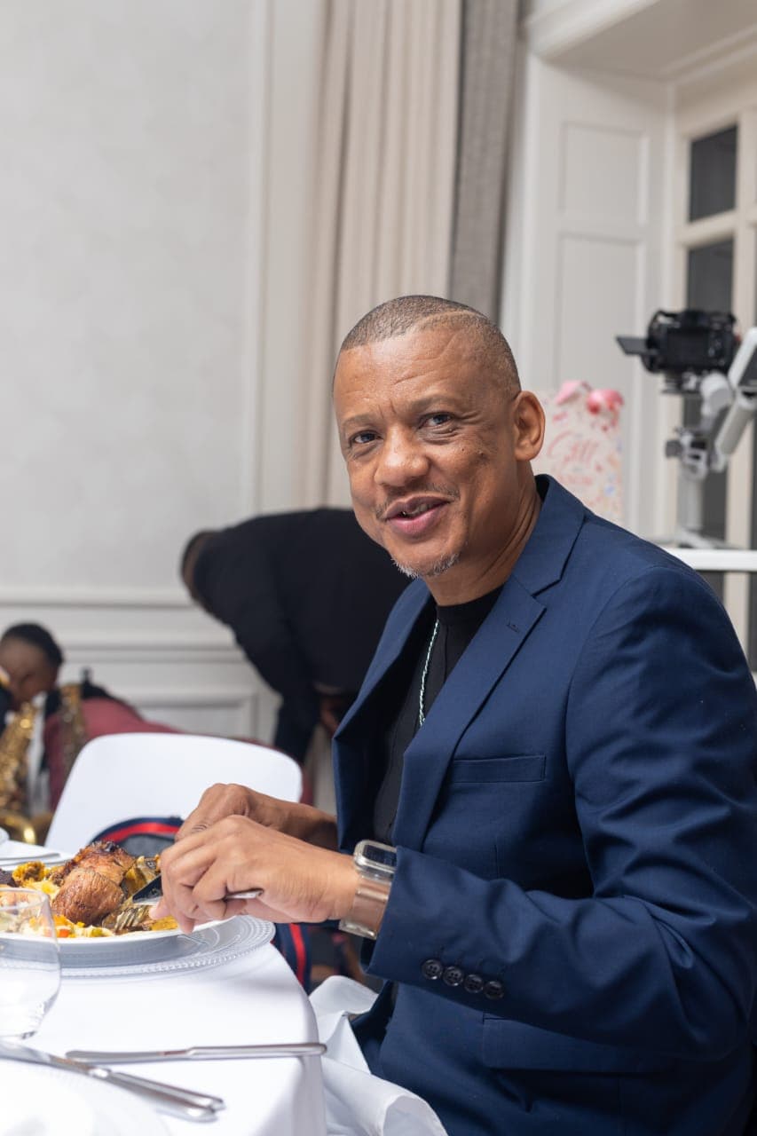 Dr. Keith Clint Harrington enjoying a meal at the Principal Princess's birthday celebration